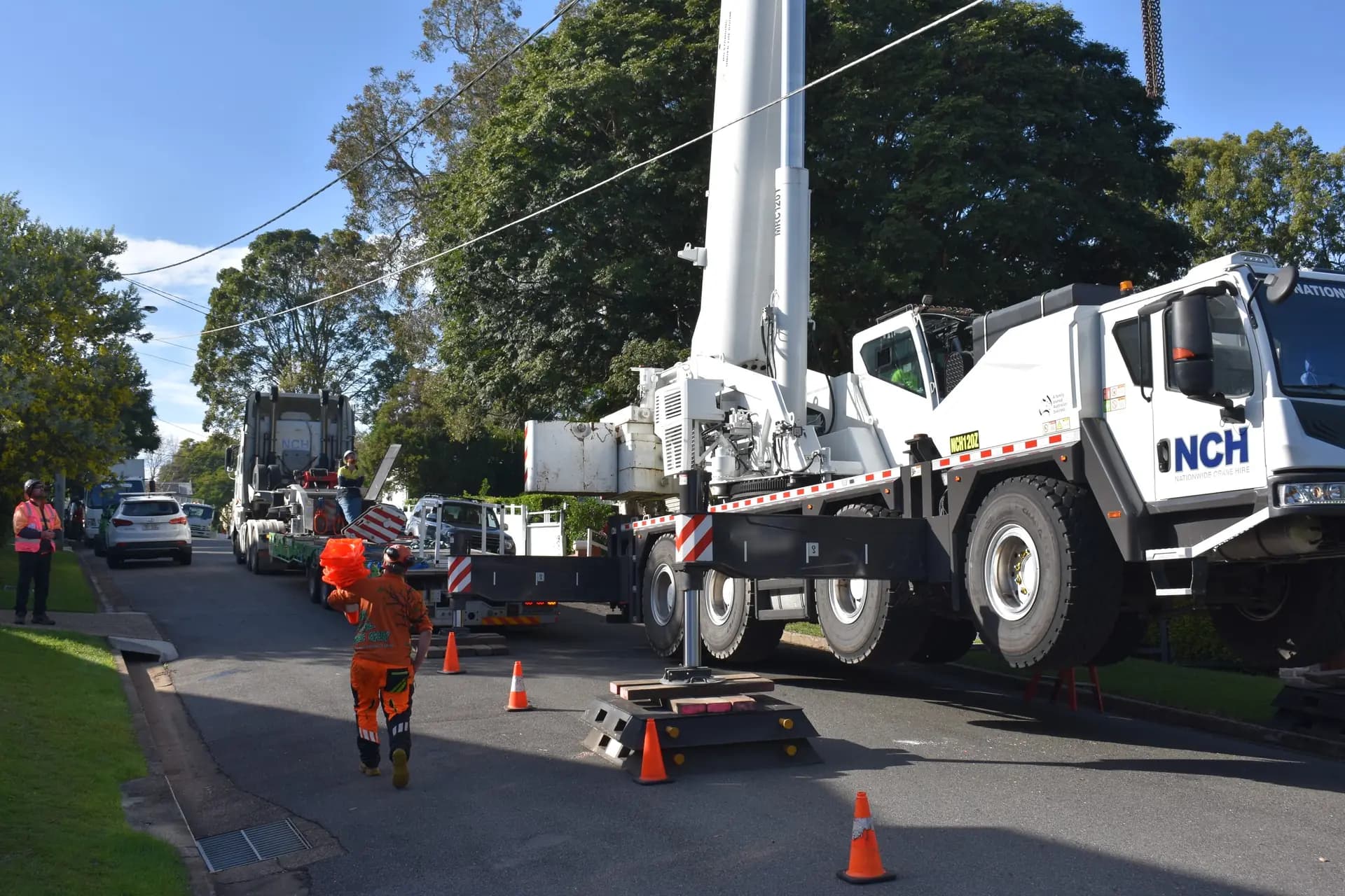 The crane set up along a residential street ahead of a large removal