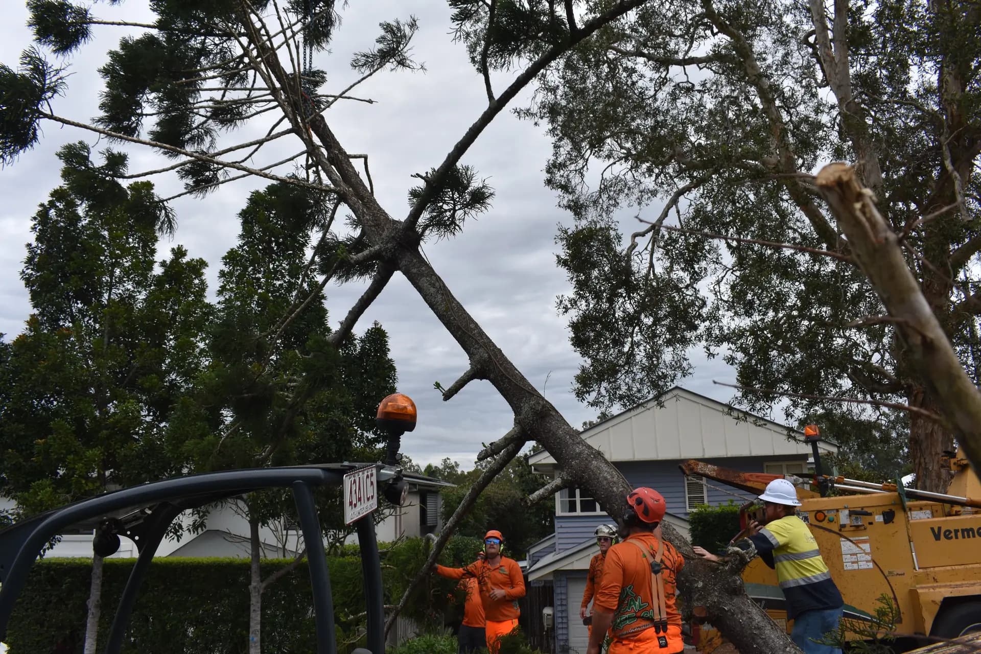 A heavy limb down across a residential roofline