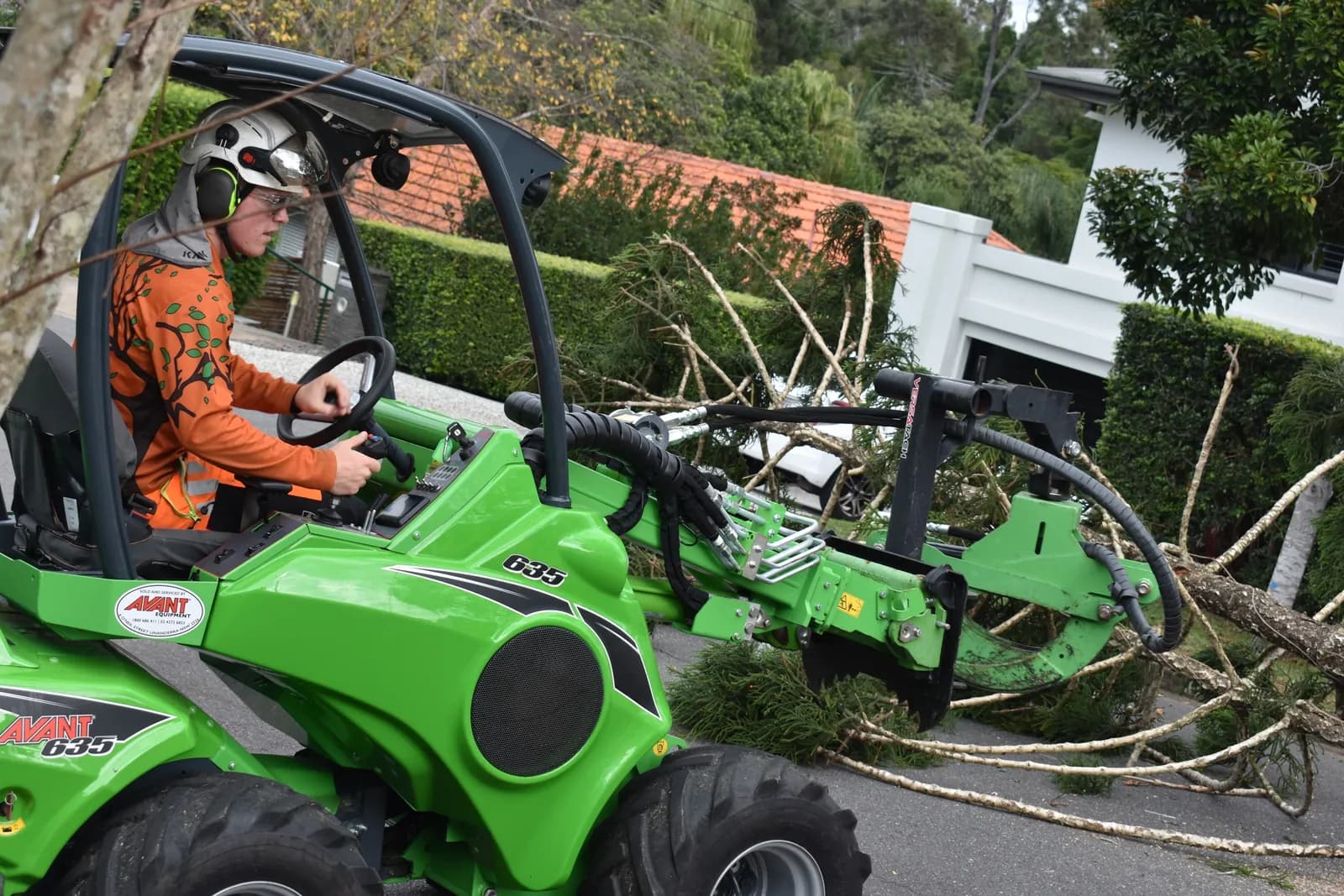 Carrying cut timber out to the street with the loader
